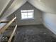 Bright attic bedroom with window and hardwood floors at 2035 Carrollton Ave, Indianapolis, IN 46202