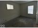 Bright bedroom with hardwood floors and two windows at 2035 Carrollton Ave, Indianapolis, IN 46202