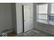 Simple bedroom with hardwood floors, a window, and a closet at 2035 Carrollton Ave, Indianapolis, IN 46202