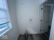 Bright laundry room with window and vinyl flooring at 2035 Carrollton Ave, Indianapolis, IN 46202