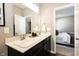 Double vanity bathroom with dark cabinets and a view of bedroom at 2394 Eagle Ave, Plainfield, IN 46168