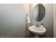 Small powder room with pedestal sink and oval mirror at 2394 Eagle Ave, Plainfield, IN 46168