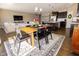 Open concept dining area with a wooden table and chairs; view of the living room and kitchen at 2394 Eagle Ave, Plainfield, IN 46168