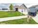 Charming brick home featuring a three-car garage, manicured lawn, and inviting curb appeal at 2394 Eagle Ave, Plainfield, IN 46168