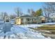 Brick ranch house with a snow covered yard and driveway at 2835 Walker Ave, Indianapolis, IN 46203