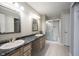 Bathroom features a double sink vanity with a shower and toilet in the background at 2926 Village Park N Dr, Carmel, IN 46033