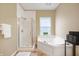 Bathroom boasts separate shower and soaking tub, plus a window for natural light at 3138 River Shore Pl, Indianapolis, IN 46208