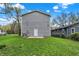 Back of the house featuring gray siding and a green lawn at 3264 Orchard Ave, Indianapolis, IN 46218