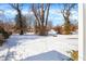 Snowy backyard with mature trees and a spacious feel at 3264 Orchard Ave, Indianapolis, IN 46218