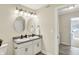 Bathroom with double vanity, granite countertop, and oval mirrors at 3264 Orchard Ave, Indianapolis, IN 46218