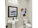 Modern bathroom with pedestal sink and contemporary art at 3264 Orchard Ave, Indianapolis, IN 46218