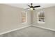 Bright bedroom with ceiling fan, carpet, and two large windows at 3264 Orchard Ave, Indianapolis, IN 46218