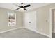 Spacious bedroom featuring a ceiling fan, double doors, and window at 3264 Orchard Ave, Indianapolis, IN 46218