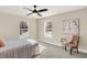 Bedroom with carpet, window, ceiling fan, and chair at 3264 Orchard Ave, Indianapolis, IN 46218