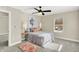 Bright bedroom with ceiling fan, window, and neutral decor at 3264 Orchard Ave, Indianapolis, IN 46218