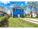 Two-story blue home featuring black shutters, a manicured lawn, and a concrete driveway at 3264 Orchard Ave, Indianapolis, IN 46218