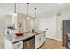 Spacious kitchen with granite island, stainless steel appliances, and white cabinets at 3264 Orchard Ave, Indianapolis, IN 46218