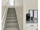 Gray carpeted stairs with a modern white railing at 3264 Orchard Ave, Indianapolis, IN 46218