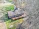 Aerial view of brick home with large deck nestled amongst bare trees at 3510 E Copperstone Rd, Martinsville, IN 46151