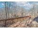 Spacious wooden back deck surrounded by mature trees in a wooded area at 3510 E Copperstone Rd, Martinsville, IN 46151