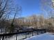 Snowy wood deck provides tranquil view of a bare, wooded lot at 3510 E Copperstone Rd, Martinsville, IN 46151