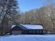 Brick home in the snow showing a charming brick ranch with attached garage at 3510 E Copperstone Rd, Martinsville, IN 46151