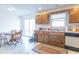 A kitchen featuring wood cabinets, laminate flooring, and a sliding door for outside access at 3510 E Copperstone Rd, Martinsville, IN 46151