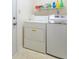 Bright laundry area with shelving above washer and dryer near an entry door at 3510 E Copperstone Rd, Martinsville, IN 46151