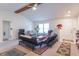 Spacious living room with neutral walls, ceiling fan, and multiple seating areas at 3510 E Copperstone Rd, Martinsville, IN 46151