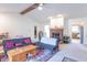 Cozy living room with fireplace and view of the kitchen, featuring neutral walls at 3510 E Copperstone Rd, Martinsville, IN 46151