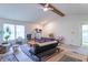 Bright living room featuring a ceiling fan, wood accent beams, and neutral walls at 3510 E Copperstone Rd, Martinsville, IN 46151