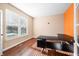 Home office with hardwood floors and an orange accent wall at 4348 Princeton Park Dr, Columbus, IN 47201