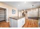 Kitchen island with granite top and white cabinets; pantry and staircase visible at 4348 Princeton Park Dr, Columbus, IN 47201