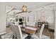 Bright dining room with hardwood floors, chandelier, and seating for six at 4543 W Meadows Ln, New Palestine, IN 46163