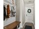 Entryway with bench, coat hooks and rustic wooden accents at 4543 W Meadows Ln, New Palestine, IN 46163
