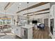 Open floor plan with kitchen island, Gathering room and exposed wooden beams at 4543 W Meadows Ln, New Palestine, IN 46163