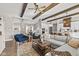 Open concept living room with hardwood floors, exposed beams, and sectional sofa at 4543 W Meadows Ln, New Palestine, IN 46163
