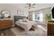 Spacious main bedroom with a gray upholstered bed and a wood dresser at 4543 W Meadows Ln, New Palestine, IN 46163