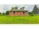 Brick home showcasing a large grassy backyard at 4657 E 62Nd St, Indianapolis, IN 46220