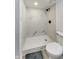 Walk-in shower with marble-style tile and frameless glass at 4657 E 62Nd St, Indianapolis, IN 46220