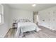 Bedroom with light green bedding and wood-look floors at 4657 E 62Nd St, Indianapolis, IN 46220
