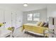 Bedroom with yellow bedding and built-in closets at 4657 E 62Nd St, Indianapolis, IN 46220