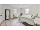 Bright bedroom with light gray bedding and wood-look floors at 4657 E 62Nd St, Indianapolis, IN 46220