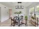 Dining area with a round table, chandelier, and shelving unit at 4657 E 62Nd St, Indianapolis, IN 46220