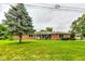 Brick ranch house with a spacious lawn and attached garage at 4657 E 62Nd St, Indianapolis, IN 46220