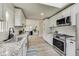 Modern kitchen featuring granite countertops, stainless steel appliances, and white cabinetry at 4657 E 62Nd St, Indianapolis, IN 46220