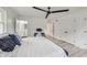 Main bedroom with hardwood floors, ceiling fan, and access to private bathroom at 4657 E 62Nd St, Indianapolis, IN 46220