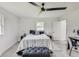 Bright bedroom with a queen bed, ottoman, and workspace at 4657 E 62Nd St, Indianapolis, IN 46220