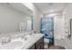 ' bathroom with double sinks, bathtub, and nautical-themed shower curtain at 4751 E Shadowbrook Dr, Camby, IN 46113
