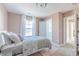 Well-lit bedroom with a comfortable bed and access to a bath at 4751 E Shadowbrook Dr, Camby, IN 46113